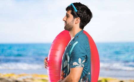 Man in trunks in lateral position at the beach