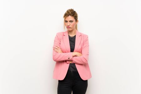 Young blonde woman with pink suit feeling upsetの写真素材