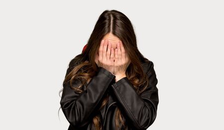 Young woman with leather jacket with tired and sick expression over isolated grey backgroundの写真素材