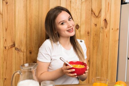 Young blonde woman having breakfast