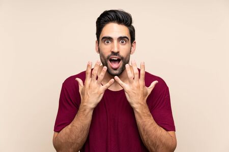 Handsome young man over isolated background with surprise facial expressionの写真素材