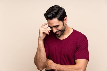 Handsome young man over isolated background laughingの写真素材
