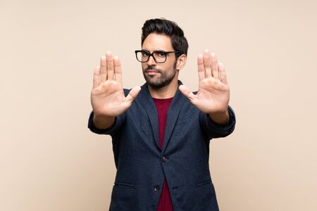 Handsome young man over isolated background making stop gesture and disappointedの写真素材