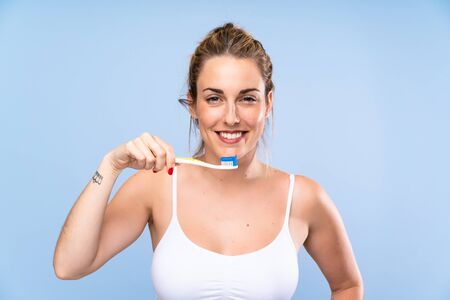 Happy Young blonde woman brushing her teethsの写真素材