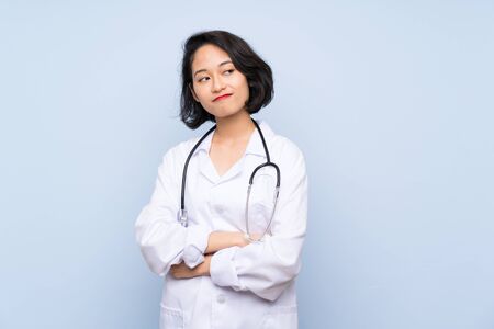 Doctor Asian woman making doubts gesture while lifting the shouldersの写真素材