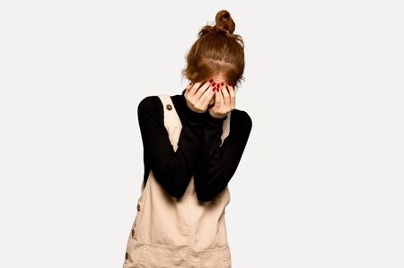 Young redhead woman with tired and sick expression over grey background