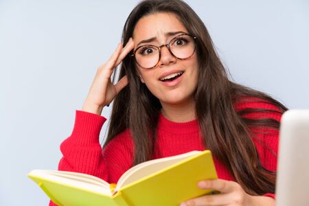 Frustrated Teenager student girl studying in a table