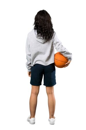 A full-length shot of a Young woman playing basketball over isolated white backgroundの写真素材