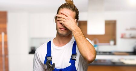 Workman covering eyes by hands. Do not want to see something in a houseの写真素材