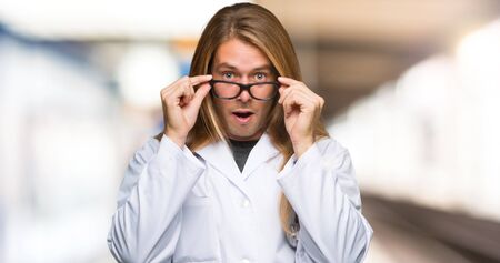 Doctor man with glasses and surprised in a hospitalの写真素材