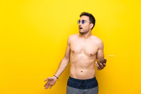 Handsome young man in summer clothes with surprise facial expressionの写真素材