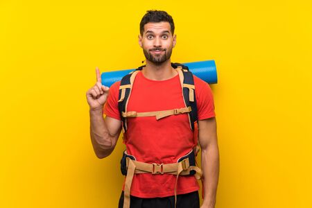 Young hiker man pointing with the index finger a great ideaの写真素材