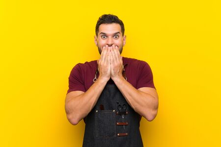 Barber man in an apron with surprise facial expressionの写真素材