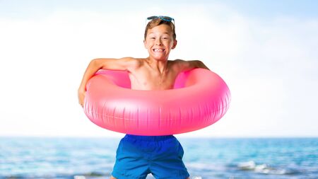 Happy child on summer vacation jumping at the beach