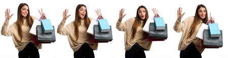 Set of young girl with shopping bags over isolated white background