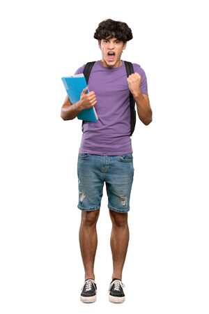 A full-length shot of a Young student man frustrated by a bad situation over isolated white backgroundの写真素材