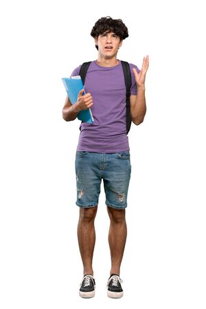 A full-length shot of a Young student man frustrated by a bad situation over isolated white backgroundの写真素材