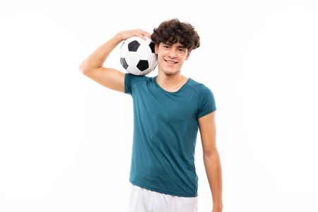 Young football player man over isolated white wallの写真素材
