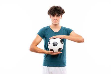 Young football player man over isolated white wallの写真素材