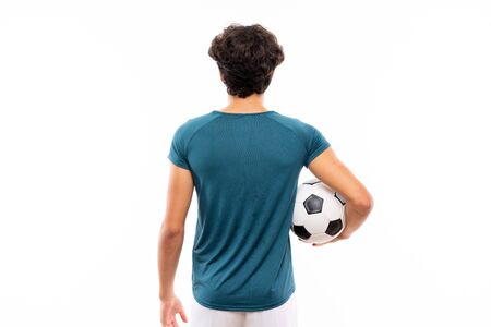 Young football player man over isolated white wallの写真素材
