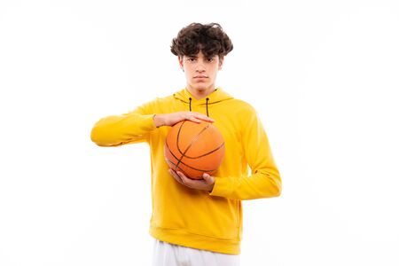 Young basketball player man over isolated white wallの写真素材