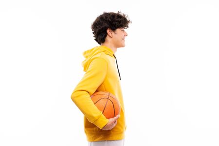 Young basketball player man over isolated white wallの写真素材