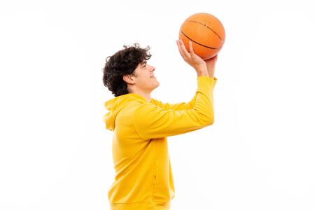 Young basketball player man over isolated white wallの写真素材