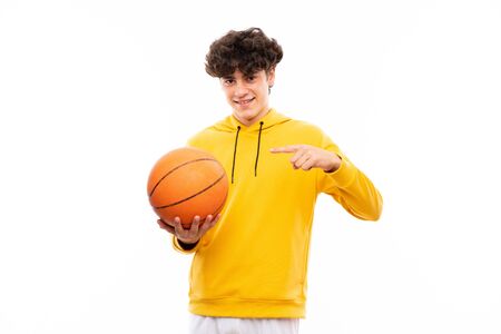 Young basketball player man over isolated white wallの写真素材