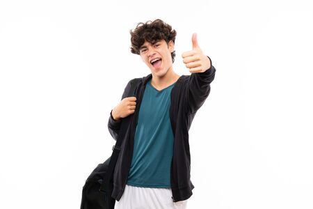 Sport man over isolated white background with thumbs up because something good has happenedの写真素材