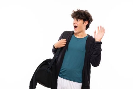 Sport man over isolated white background with surprise facial expressionの写真素材