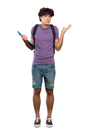 A full-length shot of a Young student man making doubts gesture over isolated white backgroundの写真素材
