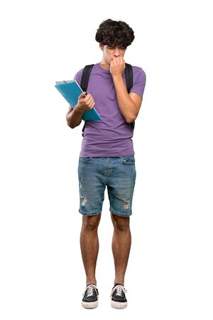 A full-length shot of a Young student man having doubts over isolated white backgroundの写真素材