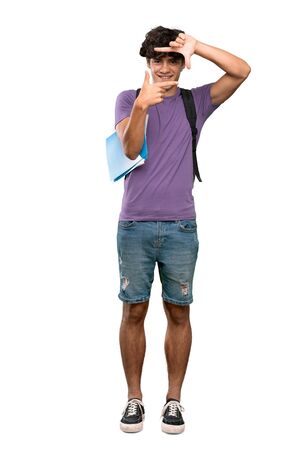A full-length shot of a Young student man focusing face. Framing symbol over isolated white backgroundの写真素材