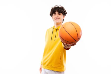 Young basketball player man over isolated white wallの写真素材