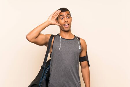 Sport man over isolated background with surprise and shocked facial expressionの写真素材