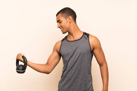 Sport man over isolated background with kettlebellの写真素材