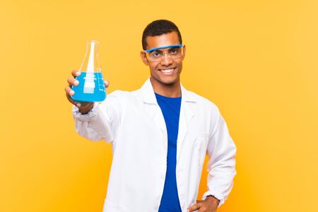 Scientific man holding a laboratory flask over isolated backgroundの写真素材