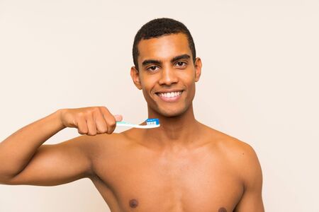 Young handsome brunette man brushing his teethの写真素材