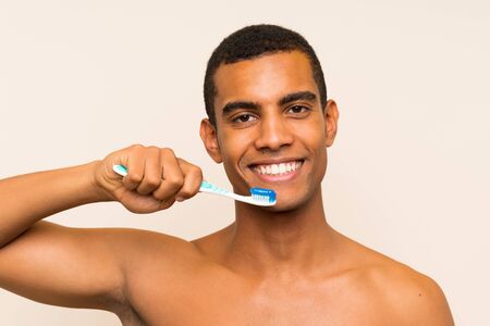 Young handsome brunette man brushing his teethの写真素材