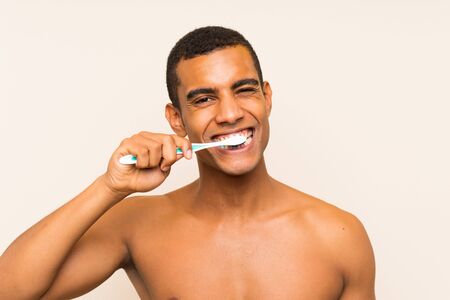 Young handsome brunette man brushing his teethの写真素材