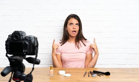 Young girl recording a video tutorial pointing with the index finger a great ideaの写真素材