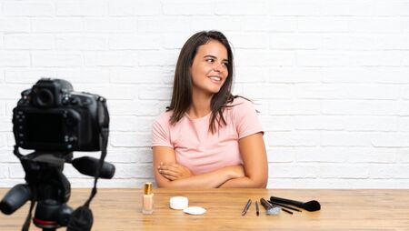 Young girl recording a video tutorial laughingの写真素材