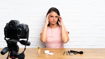 Young girl recording a video tutorial unhappy and frustrated with something. Negative facial expressionの写真素材