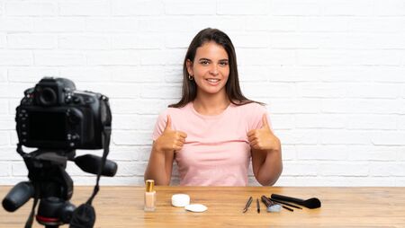 Young girl recording a video tutorial giving a thumbs up gestureの写真素材