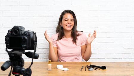 Young girl recording a video tutorial laughingの写真素材
