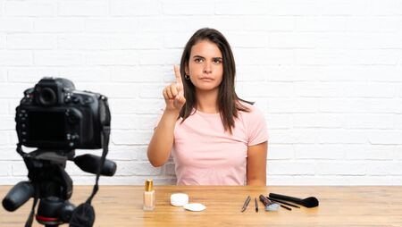 Young girl recording a video tutorial touching on transparent screenの写真素材