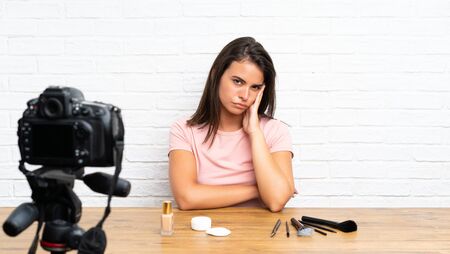 Young girl recording a video tutorial unhappy and frustratedの写真素材