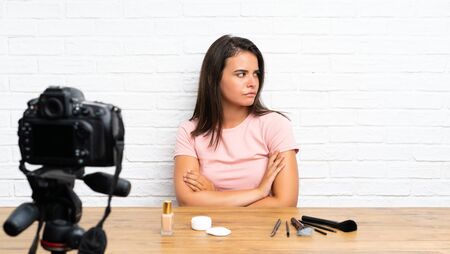 Young girl recording a video tutorial thinking an ideaの写真素材