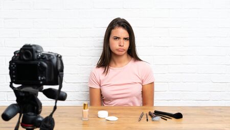 Young girl recording a video tutorial sadの写真素材