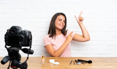 Young girl recording a video tutorial pointing with the index finger a great ideaの写真素材